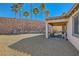 Desert landscape with covered patio, block wall, and gravel at 685 Viale Machiavelli Ln, Henderson, NV 89011