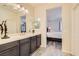 Bathroom with double vanity and view into bedroom at 685 Viale Machiavelli Ln, Henderson, NV 89011