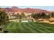 Tuscan-style golf course with a pond and mountain views at 685 Viale Machiavelli Ln, Henderson, NV 89011