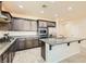 Spacious kitchen featuring granite countertops and dark wood cabinets at 685 Viale Machiavelli Ln, Henderson, NV 89011