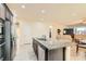 Open kitchen with large island and granite countertops, view of living room at 685 Viale Machiavelli Ln, Henderson, NV 89011