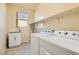 Laundry room with washer, dryer, and extra shelving at 685 Viale Machiavelli Ln, Henderson, NV 89011