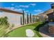 Backyard with putting green, landscaping, and privacy wall at 7230 Galaxy Dune St, Las Vegas, NV 89148