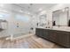 Spa-like bathroom with a large walk-in shower, double vanity, and marble tile at 7230 Galaxy Dune St, Las Vegas, NV 89148