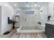 Large bathroom features a walk-in shower with glass enclosure and grey vanity at 7230 Galaxy Dune St, Las Vegas, NV 89148