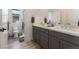 Double vanity bathroom with modern grey cabinets and quartz countertop at 7230 Galaxy Dune St, Las Vegas, NV 89148