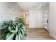 Bright entryway with wood-look floors and a feature stone wall at 7230 Galaxy Dune St, Las Vegas, NV 89148