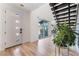 Bright entryway with modern door, hardwood floors, and a contemporary staircase at 7230 Galaxy Dune St, Las Vegas, NV 89148