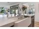 Modern kitchen island with farmhouse sink and faucet at 7230 Galaxy Dune St, Las Vegas, NV 89148