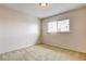 Well-lit bedroom featuring a large window and carpet at 7232 Raincloud Dr, Las Vegas, NV 89145