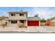 Two-story house with red garage door and small front yard at 7232 Raincloud Dr, Las Vegas, NV 89145