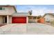 Red garage door with covered carport and ample parking space at 7232 Raincloud Dr, Las Vegas, NV 89145