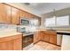 Modern kitchen with stainless steel appliances and light wood cabinets at 7232 Raincloud Dr, Las Vegas, NV 89145