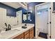 Bathroom with a double vanity, navy blue walls and a shower/tub combo at 7528 Stray Horse Ave, Las Vegas, NV 89113