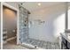 Spa-like bathroom with patterned tile shower and glass enclosure at 7528 Stray Horse Ave, Las Vegas, NV 89113