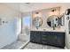 This bathroom features dual sinks, modern fixtures, and a beautifully tiled walk-in shower at 7528 Stray Horse Ave, Las Vegas, NV 89113