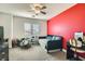 This bright bedroom features a playful accent wall, comfortable seating, and ample natural light at 7528 Stray Horse Ave, Las Vegas, NV 89113