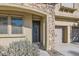 Charming front door entrance with stonework and landscaping at 7528 Stray Horse Ave, Las Vegas, NV 89113