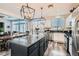 Bright kitchen with stainless steel appliances, granite counters, island, and pendant lighting at 7528 Stray Horse Ave, Las Vegas, NV 89113