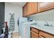 This practical laundry room features modern appliances, ample storage, and a convenient utility sink at 7528 Stray Horse Ave, Las Vegas, NV 89113