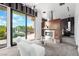 Main bedroom with fireplace, sitting area, and sliding glass doors to backyard at 78 Hawk Ridge Dr, Las Vegas, NV 89135