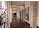 Long hallway with stone walls and artwork at 78 Hawk Ridge Dr, Las Vegas, NV 89135