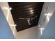 Modern hallway with abstract art and stone accent walls at 78 Hawk Ridge Dr, Las Vegas, NV 89135