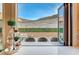 View of backyard through kitchen window; features a patio and mountain views at 821 Barrhead Ave, Henderson, NV 89012