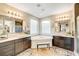 Elegant bathroom with double vanities, soaking tub, and walk-in shower at 821 Barrhead Ave, Henderson, NV 89012