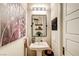 Modern powder room with pedestal sink and decorative mirror at 821 Barrhead Ave, Henderson, NV 89012