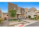 Contemporary home with stone exterior and a landscaped front yard at 821 Barrhead Ave, Henderson, NV 89012