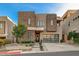 Modern home with stone exterior, landscaped yard, and two-car garage at 821 Barrhead Ave, Henderson, NV 89012