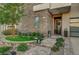 Attractive entryway with stone facade, landscaping, and a welcoming bench at 821 Barrhead Ave, Henderson, NV 89012