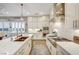 Modern kitchen with white cabinets, herringbone backsplash, and stainless steel appliances at 821 Barrhead Ave, Henderson, NV 89012