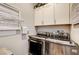 Bright laundry room with washer, dryer, and ample cabinet space at 821 Barrhead Ave, Henderson, NV 89012