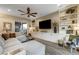 Bright and airy living room with sectional sofa, built-in shelves, and hardwood floors at 821 Barrhead Ave, Henderson, NV 89012