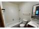 Standard white tiled bathroom featuring a toilet, tub, and vanity with sink at 855 Del Rey Dr, Boulder City, NV 89005