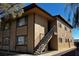 Tan two-story building with a metal staircase and dark-framed windows at 855 Del Rey Dr, Boulder City, NV 89005