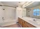 Bathroom with a tub, shower, and double vanity sink with wood cabinets at 86 Myrtle Beach Dr, Henderson, NV 89074