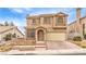 Two-story house with beige exterior, attached garage, and landscaping at 86 Myrtle Beach Dr, Henderson, NV 89074