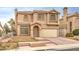 Beige two-story house with attached garage and front yard at 86 Myrtle Beach Dr, Henderson, NV 89074