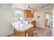 Bright kitchen featuring granite countertops, white tile backsplash, stainless steel sink, and an arched window at 86 Myrtle Beach Dr, Henderson, NV 89074