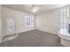 A well-lit living room with carpet, fireplace, and an oval window in the front door at 86 Myrtle Beach Dr, Henderson, NV 89074