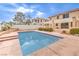 Backyard pool with patio, landscaping, partial home exterior, and brick wall in the background at 86 Myrtle Beach Dr, Henderson, NV 89074