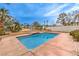 A refreshing pool surrounded by decorative coping and beautiful landscaping under a bright sky at 86 Myrtle Beach Dr, Henderson, NV 89074