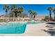 Community swimming pool with lounge chairs and palm trees at 8658 Tom Noon Ave # 103, Las Vegas, NV 89178