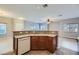 Kitchen island with sink, dishwasher, and wood cabinets at 8658 Tom Noon Ave # 103, Las Vegas, NV 89178