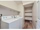 Laundry room with washer, dryer, shelving and light wood flooring at 8658 Tom Noon Ave # 103, Las Vegas, NV 89178