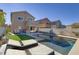 House with a backyard pool, patio, and artificial turf at 9570 Wenmarie Ct, Las Vegas, NV 89148