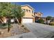 Two-story house with a white garage door and landscaping at 9570 Wenmarie Ct, Las Vegas, NV 89148